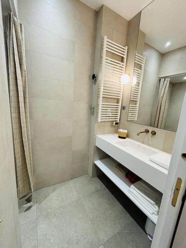 une salle de bain avec un lavabo et un miroir dans l'établissement Modern apt Canal st Martin, à Paris