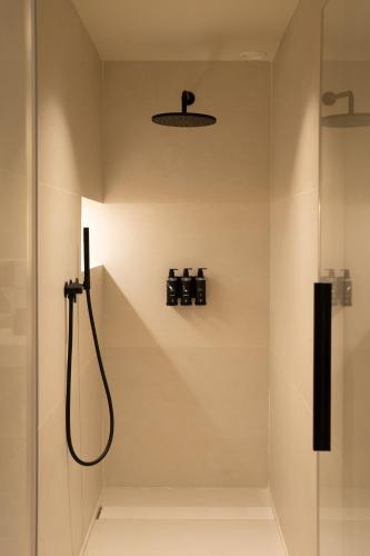 a bathroom with a shower with a shower head at Ocean Drive Sevilla in Seville