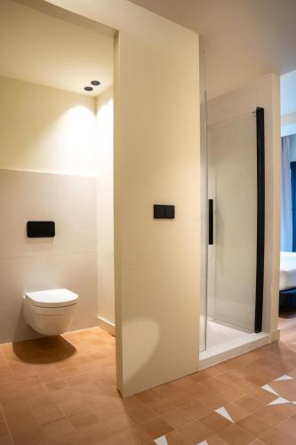 a bathroom with a toilet and a shower stall at Ocean Drive Sevilla in Seville