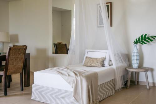a bedroom with a bed with a mosquito net at Melia Zanzibar in Kiwengwa