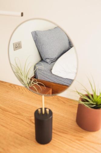 a mirror on a table with a couch in a room at Boy apartment -Adult only in Hualien City