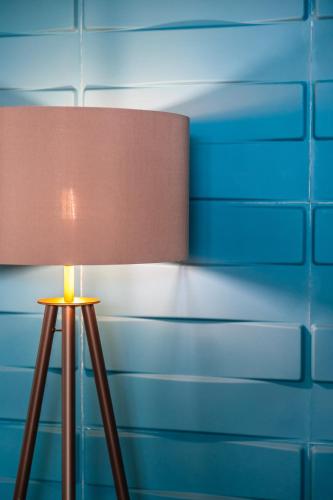 a brown lamp sitting in front of a blue wall at Hotel Orizzonte in Lido di Jesolo