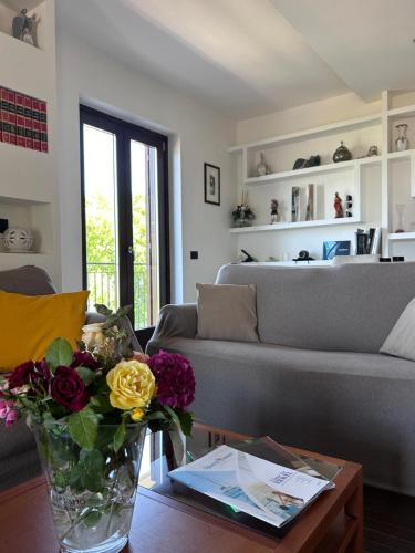 a living room with a couch and a vase of flowers on a table at Villa Amalia in Avellino