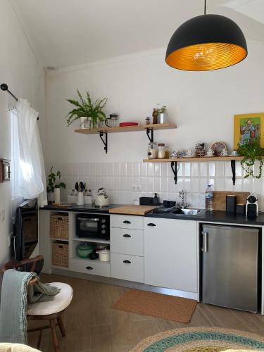 a kitchen with a sink and a stove top oven at Casa do Montinho in Caminha
