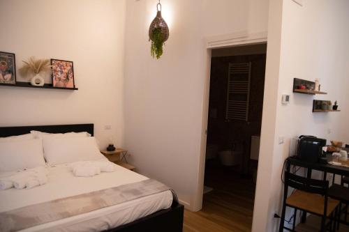 a bedroom with a bed with towels on it at Welchome Apartment and Luxury Rooms in Grumo Appula