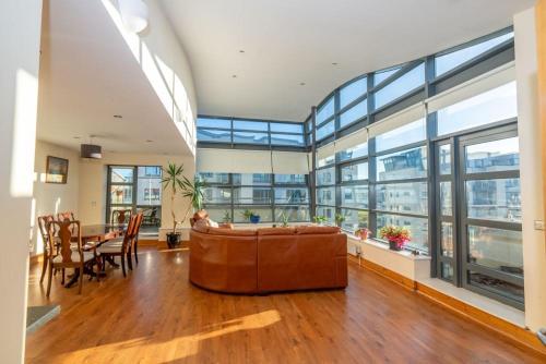 a large living room with a couch and a table at Panoramic Two-bedroom Penthouse in Cork