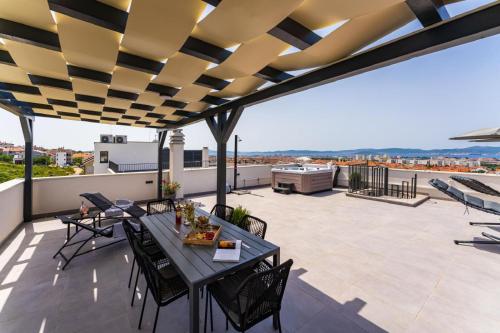 a patio with a table and chairs on a roof at Luxury Penthouse ARIA in Zadar