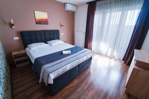 Postel nebo postele na pokoji v ubytování Guest House Babilon