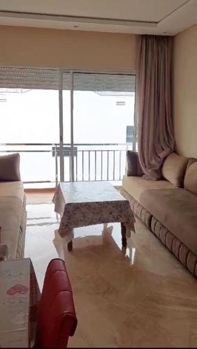 a living room with a couch and a coffee table at Les jardins de bouznika in Bouznika