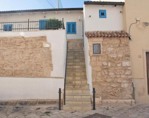 a stairway leading up to a white building at Le Casette in Brindisi