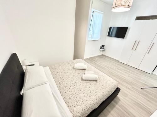a bedroom with a bed with two towels on it at Un Letto Ideale EUR in Rome