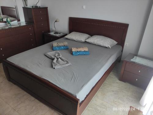 a bedroom with a bed with two bags on it at Villa Mary in Makrýgialos