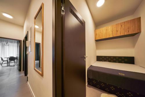 a small bedroom with a bunk bed and a hallway at Aparthotel Svatý Vavřinec in Pec pod Sněžkou