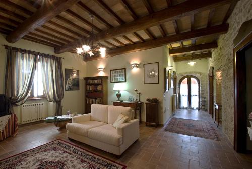 a living room with a couch and a table at Casale del Monsignore in Spoleto