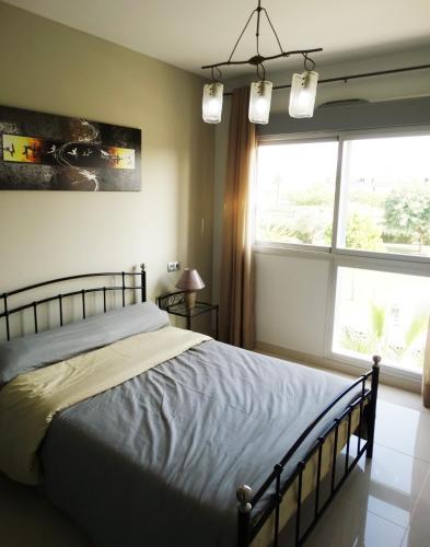 a bedroom with a bed and a large window at Apartment Escorpiones in Torrevieja