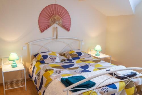 a bedroom with a bed with a colorful comforter at Meuble de tourisme du haut 5 personnes a serigas in Meyrueis