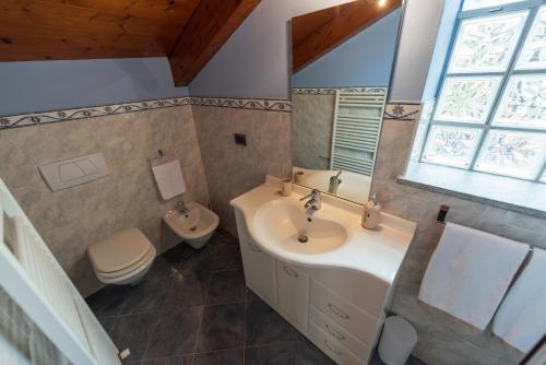 a bathroom with a sink and a toilet at AdaGio Holiday Home, Alba center in Alba
