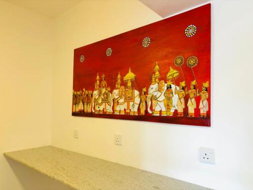 a painting hanging on a wall in a room at Havelock City Hostel, Colombo in Colombo