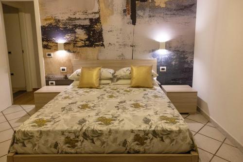a bedroom with a large bed with yellow pillows at Dream Garden in Scafati