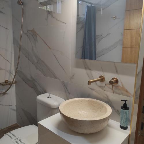 a bathroom with a bowl sink on a counter at Maria's Apartment Nafplio in Nafplio