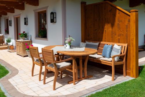a wooden table and chairs on a patio at Appartement Auszeit in Alpbach