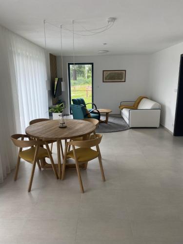 a living room with a wooden table and chairs at Nad Soutokem in Volary