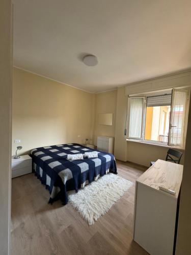 a bedroom with a blue and white bed and a rug at Casa Facetti presso HOTEL KRISTALL in Diano Marina