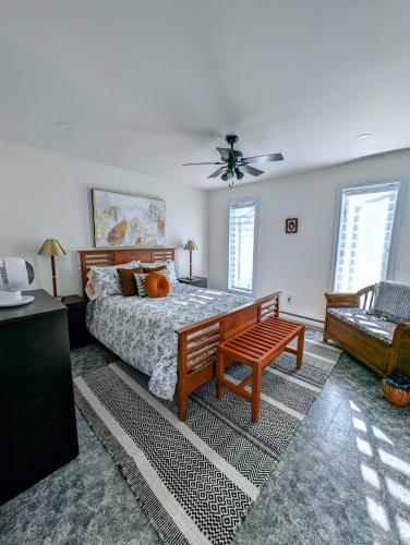 a bedroom with a bed and a table and a couch at La Maison Kelner in Saint Ludger de Milot