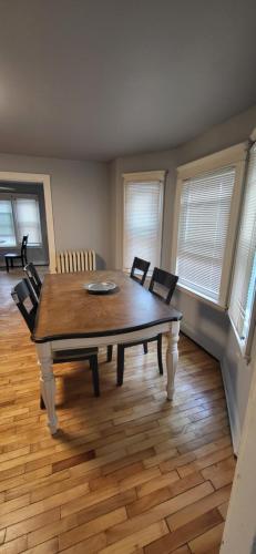 a dining room with a wooden table and chairs at Oakdale Area Nice Location in Portland