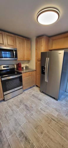 a kitchen with a stainless steel refrigerator and stove at Oakdale Area Nice Location in Portland