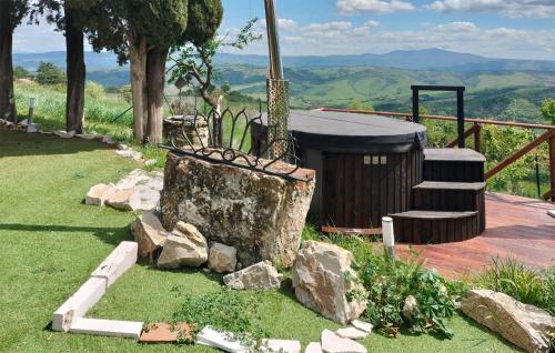 a tree stump with a hot tub and some rocks at Pet Friendly Home In Campiglia D'orcia in Campiglia dʼOrcia