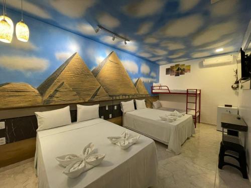 En eller flere senge i et værelse på Pousada Country K no Parque Aquamak