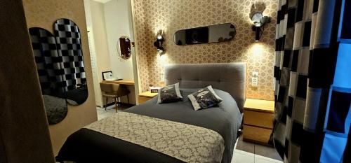 a bedroom with a bed and a tv on the wall at Mei Hôtel-Restaurant in Sarrebourg