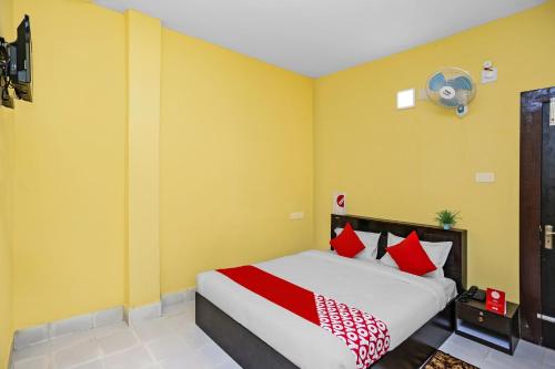 a bedroom with a bed with red and white pillows at FabHotel Seven Inn in Bhubaneshwar