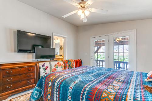 a bedroom with a bed and a flat screen tv at Remote Kingston Cabin with Mtn Views Fish and ATV! in Antimony
