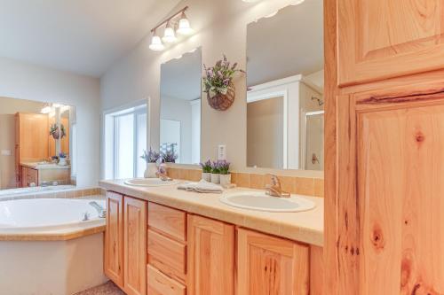 a bathroom with two sinks and a large mirror at Remote Kingston Cabin with Mtn Views Fish and ATV! in Antimony
