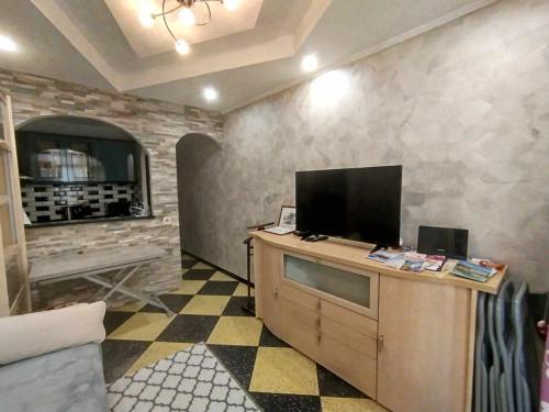 Televízia a/alebo spoločenská miestnosť v ubytovaní Charmant appartement au cœur de Tarascon