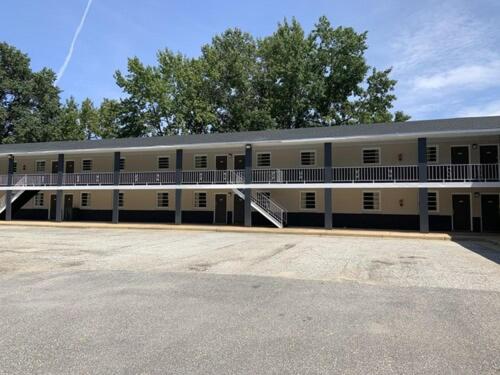 a large white building with a lot of windows at Paradise Suites - Newport News & Jefferson Ave in Newport News