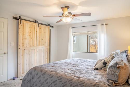 a bedroom with a bed and a ceiling fan at Stunning Javelina Hideaway with Hot Tub and King Bed in Sedona