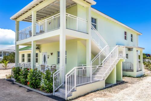 a house with white and green at Tropical Jungle Oasis with Lagoon Views, Good WiFi in Providenciales