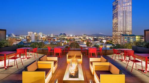 a rooftop patio with tables and chairs and a fire pit at Luxury 1Bedroom 1Bath Pearl District in Portland