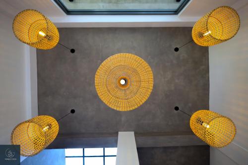 a group of yellow lights hanging from a ceiling at Forest Face Lodge in Gurudeniya