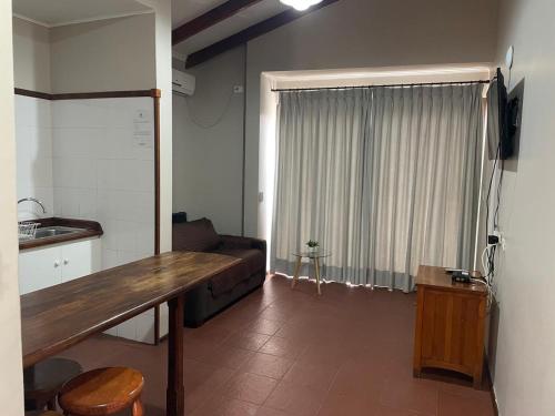 a living room with a couch and a table in a room at Hotel Altos de Tuqui in Ovalle