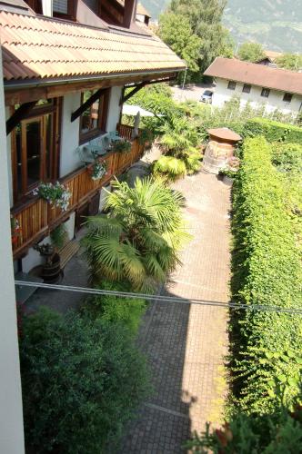 a walkway in front of a house with plants at Neuprantl Apartments in Lana