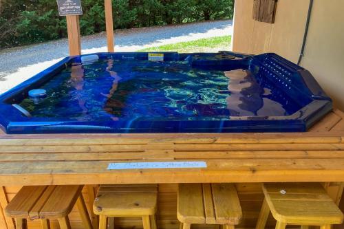 a hot tub sitting on top of a wooden table at Lucky Clover Cabin in Blairsville