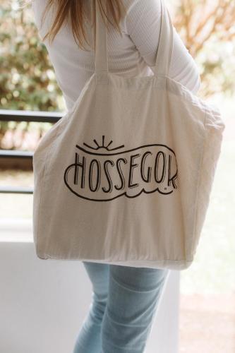 a woman holding a bag with the word moscolo on it at Maison du Parc - Vue canal in Hossegor