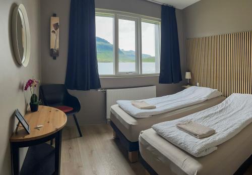 Rúm í herbergi á Stöð Guesthouse and apartments