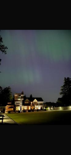 a house is lit up at night with lights at The Manor Boutique Hotel Restaurant and Bar in Conwy