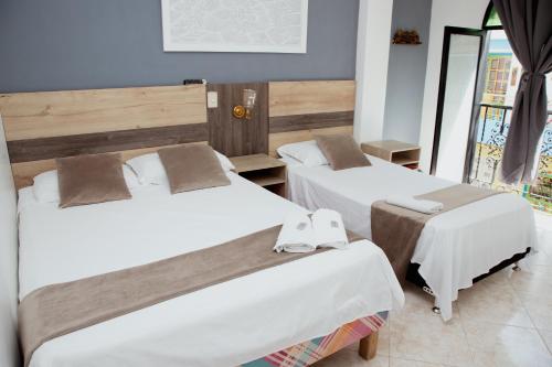 Ein Bett oder Betten in einem Zimmer der Unterkunft Hotel Real Guatapé