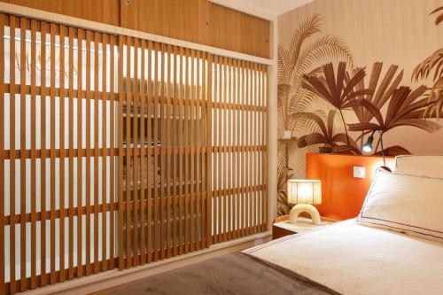 a bedroom with a bed and a large window at Superbe maison sur pilotis in Savy-Berlette